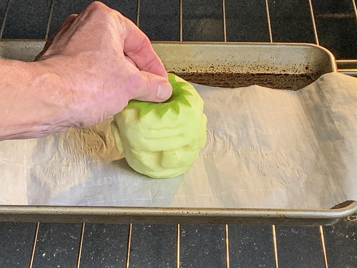Placing an apple head in the oven
