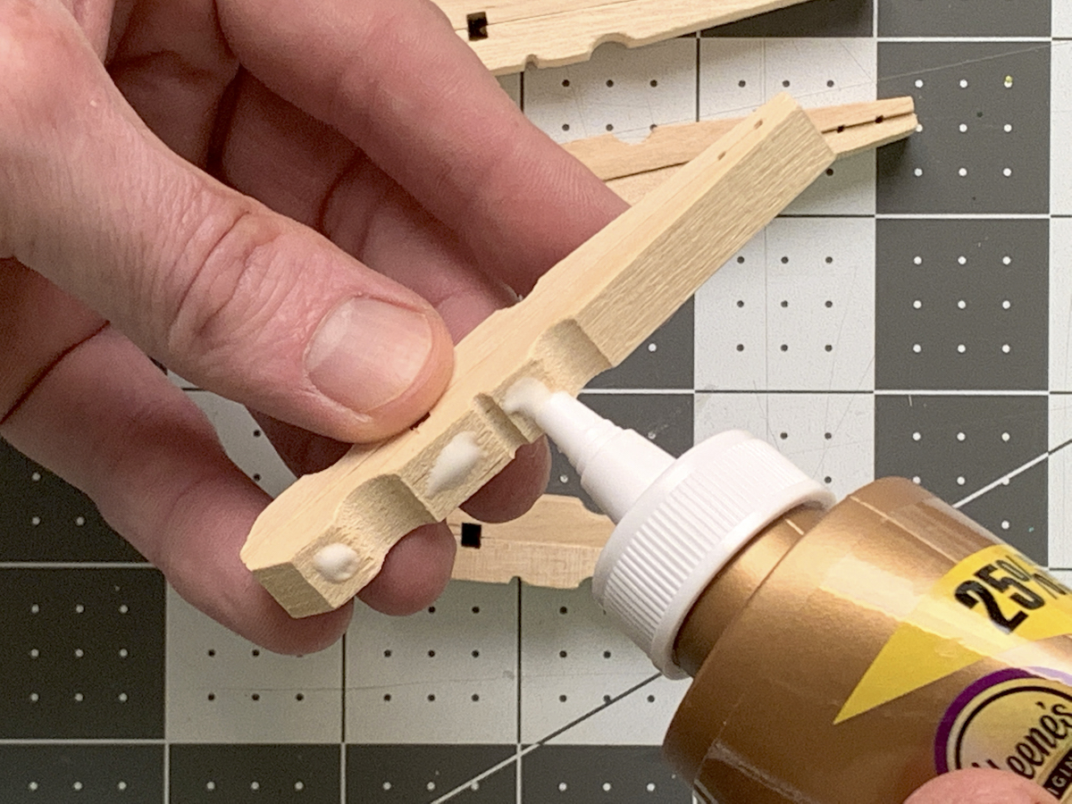 Placing craft glue on a clothespin