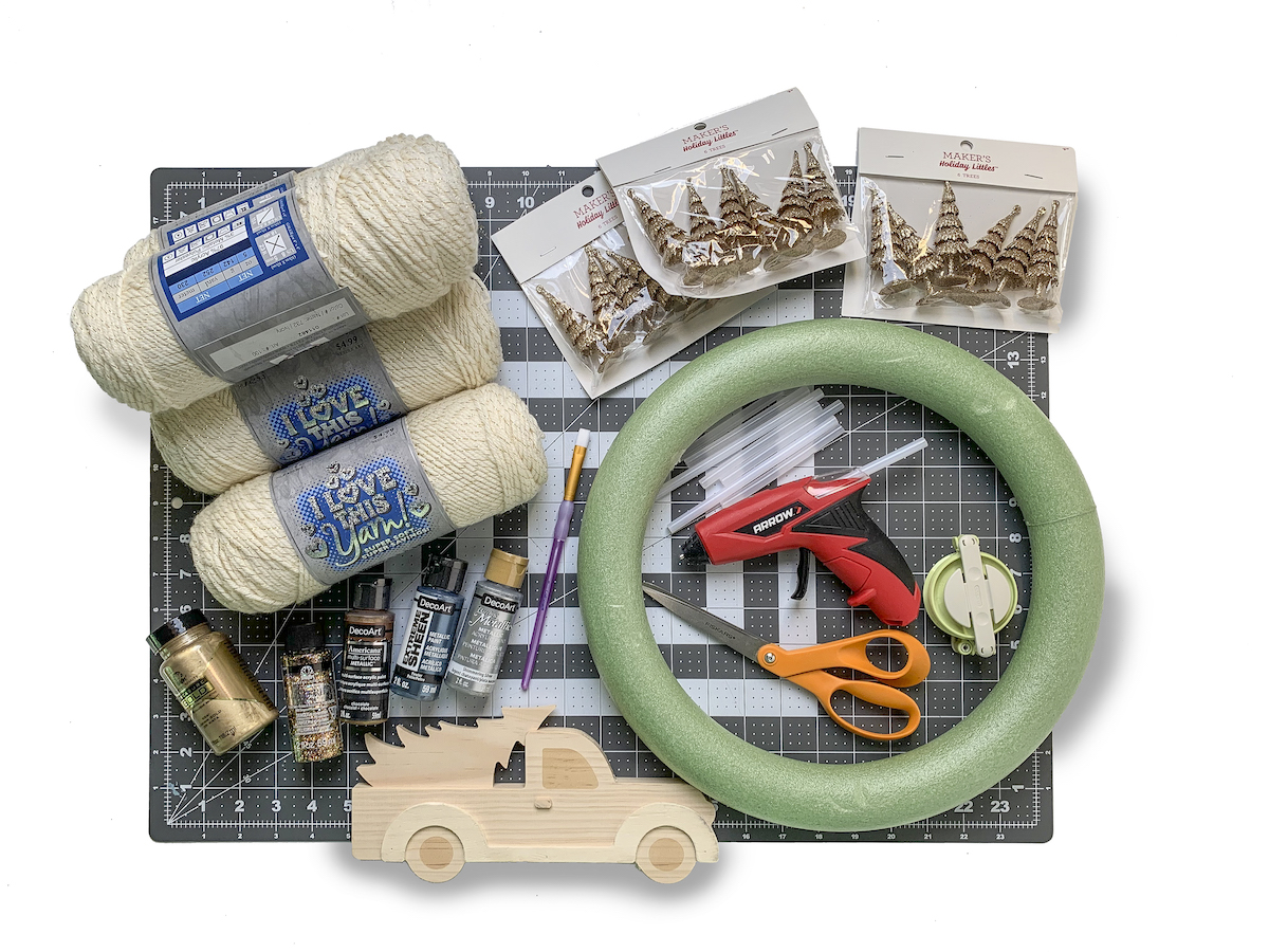 Yarn, wreath form, hot glue gun, and other wreath making supplies