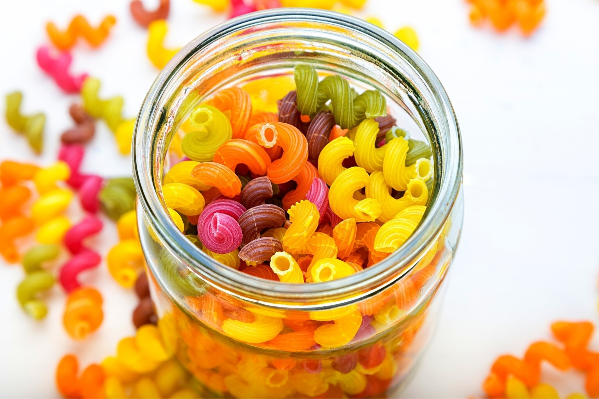 Multicolored dry pasta in a jar