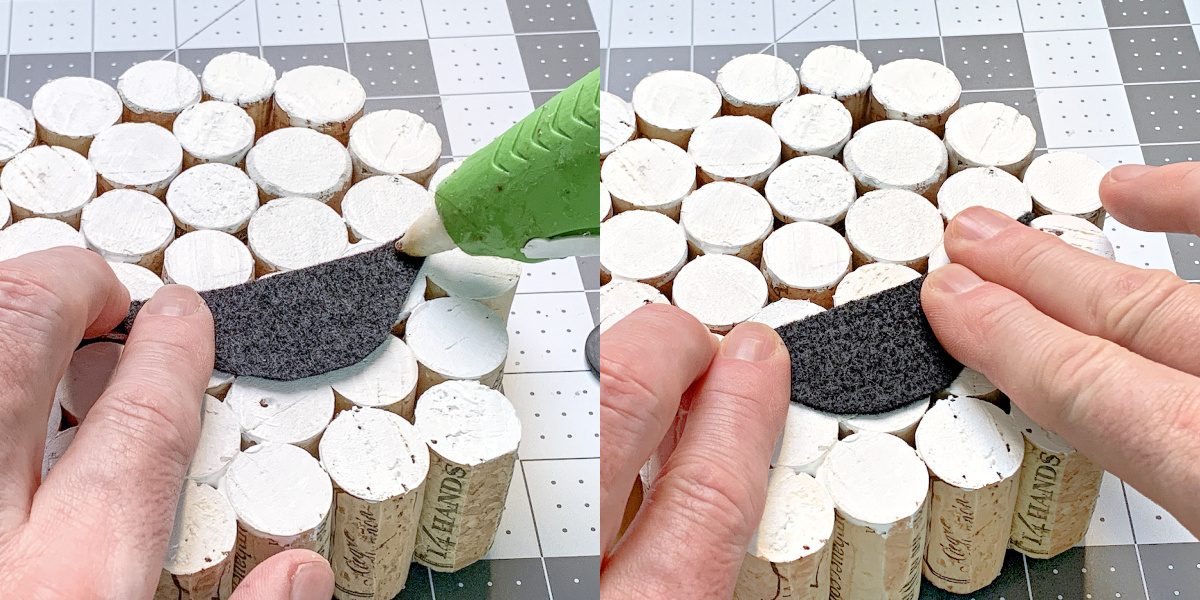 Attaching a felt black mouth to wine corks with hot glue