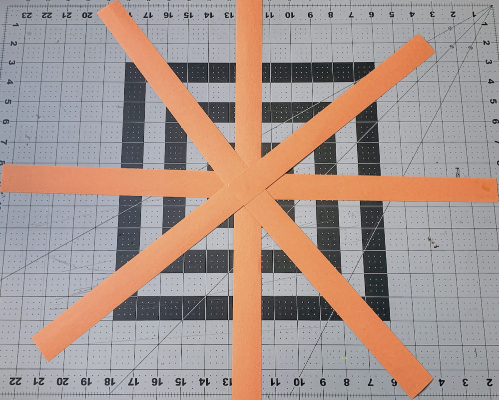 Strips of orange construction paper forming a star shape