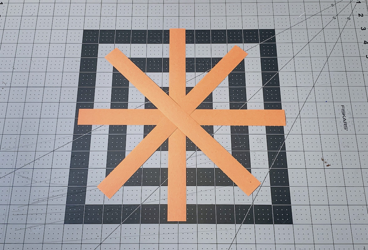 Strips of orange paper to make a smaller paper pumpkin