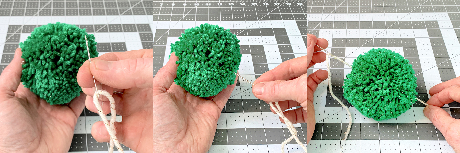 Yarn on a needle being inserted into a green pom pom