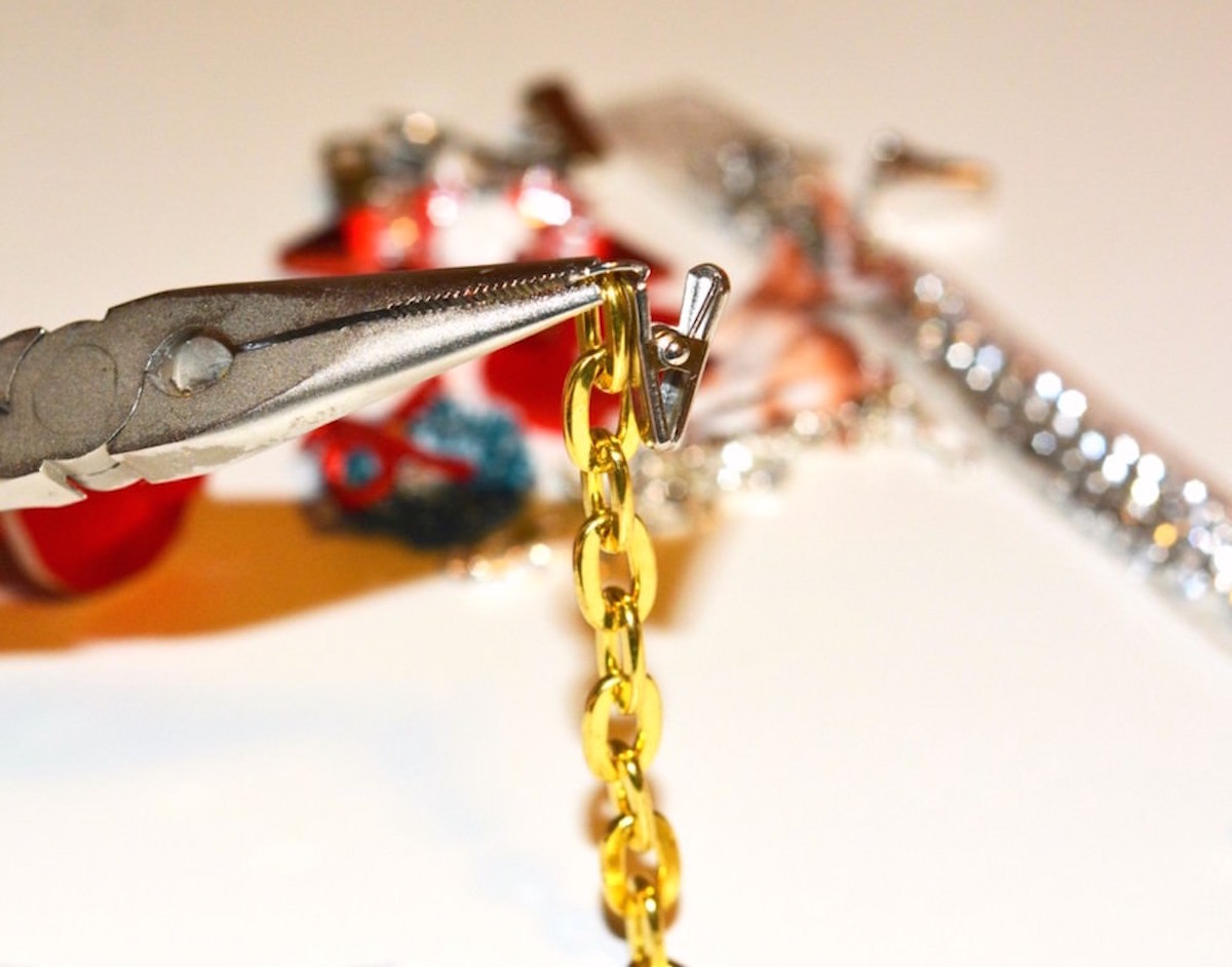 Attaching an alligator clip to a piece of chain with a jewelry tool