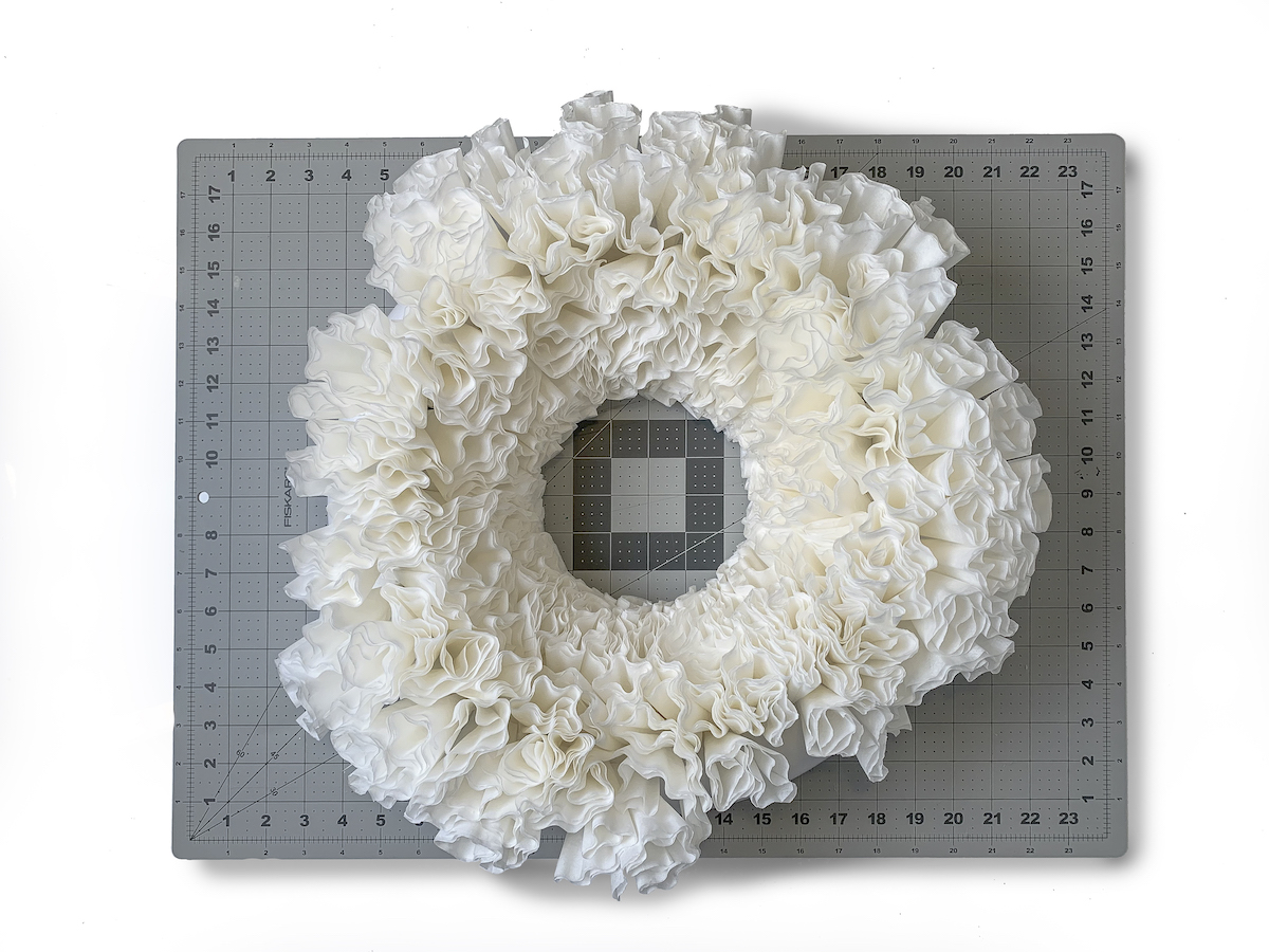 Second row of coffee filters added to the wreath form