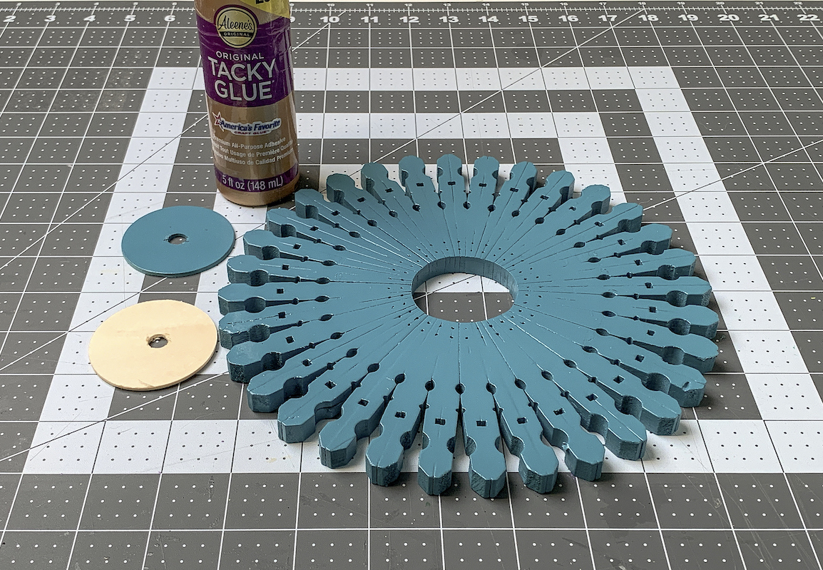 Spray painted clothespin base with wood circles and craft glue