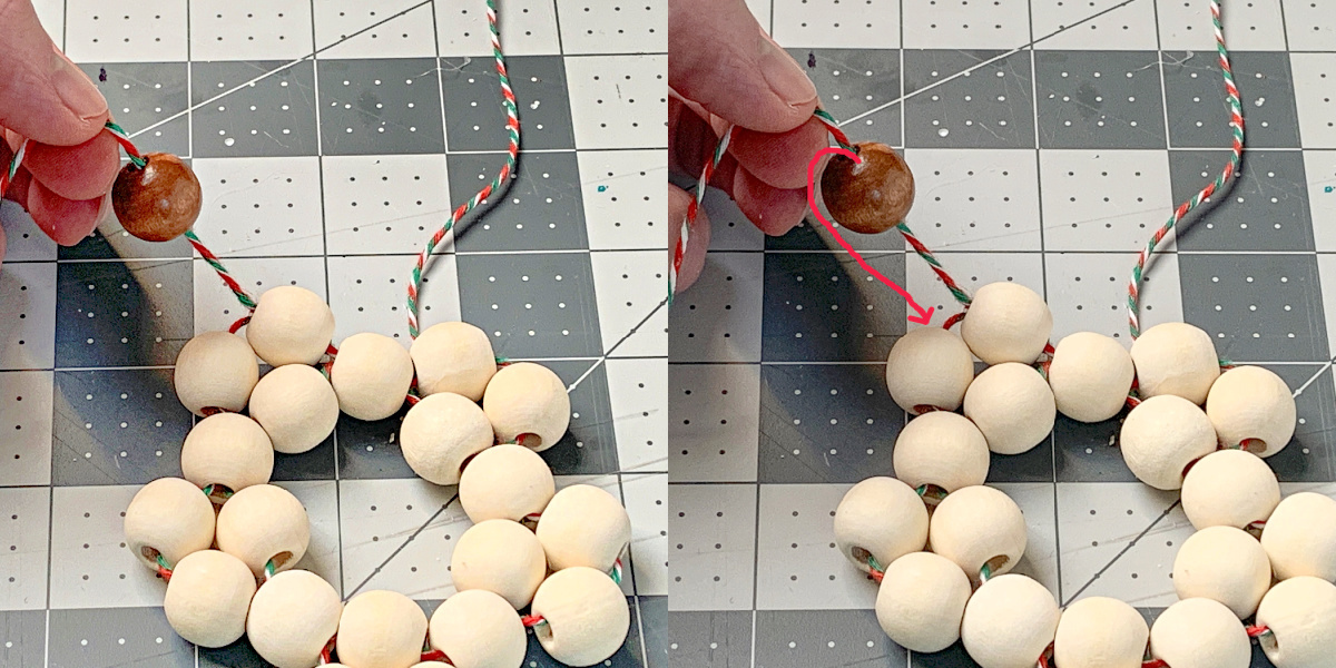 Stringing a stained wood bead onto the ornament