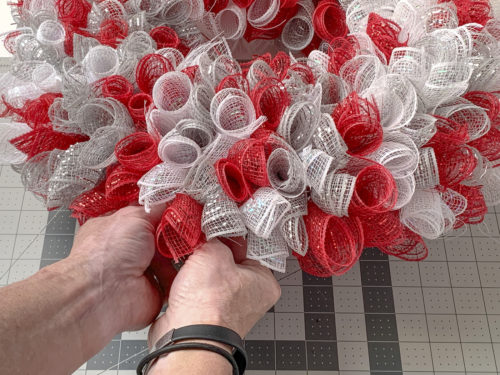 Attaching the final mesh piece to the Christmas wreath