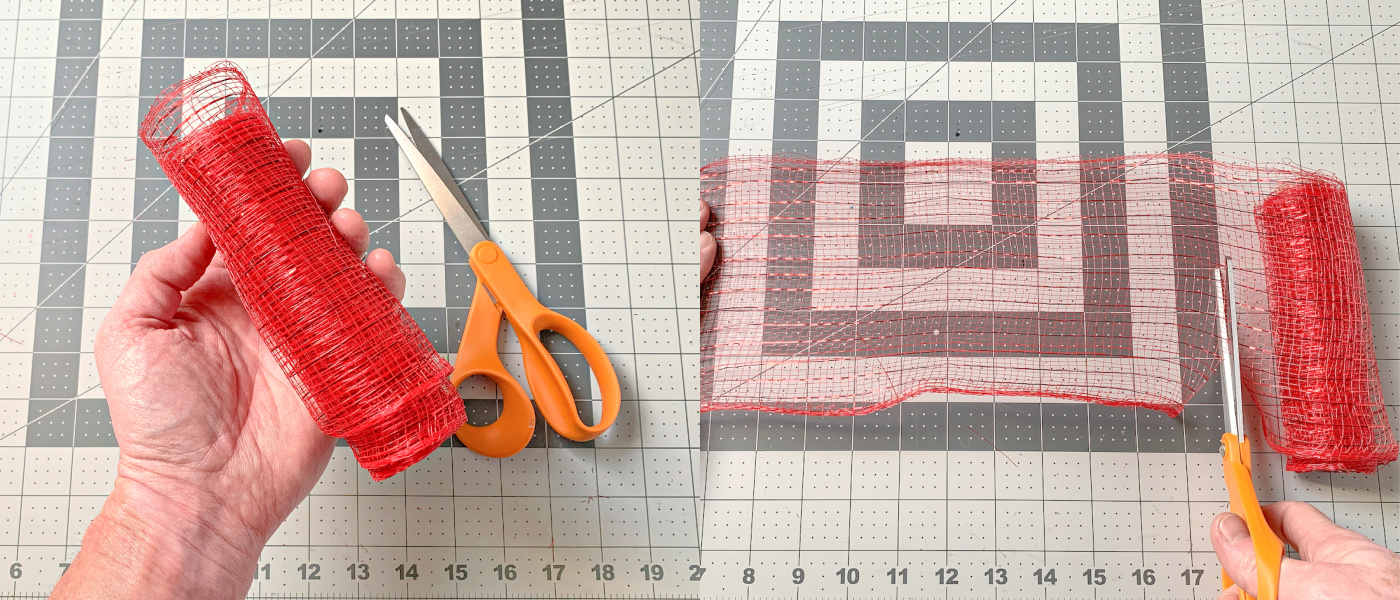 Cutting a 10 inch length of red deco mesh using scissors