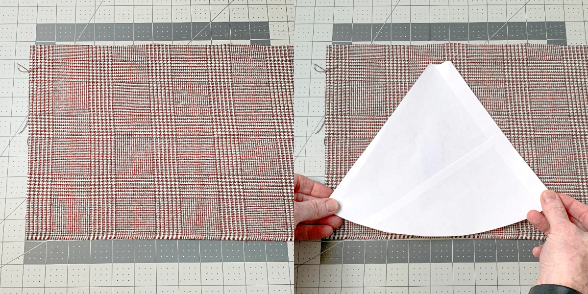 Hands placing a template on herringbone flannel fabric