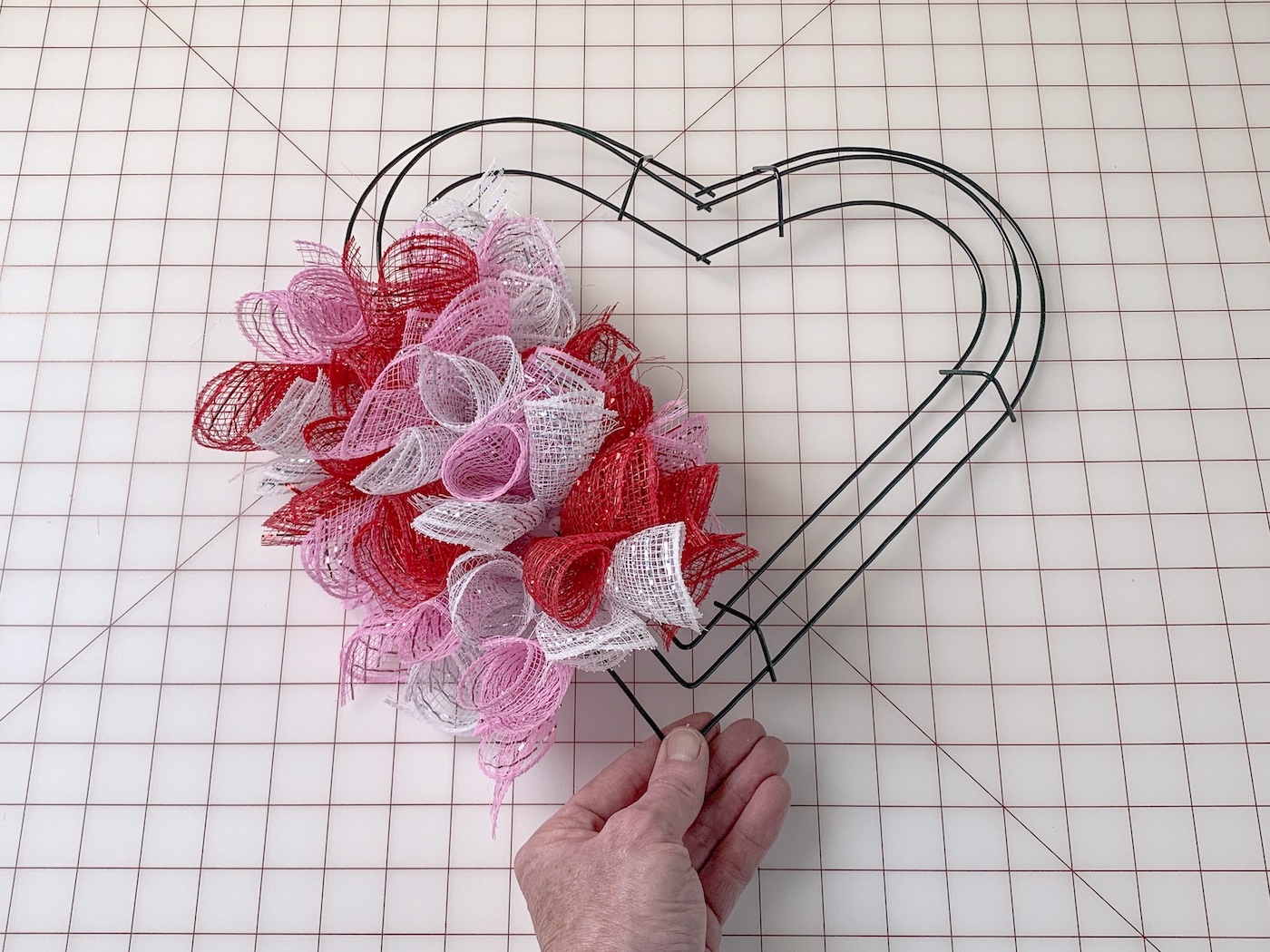 Heart shaped wreath form partially covered in deco mesh