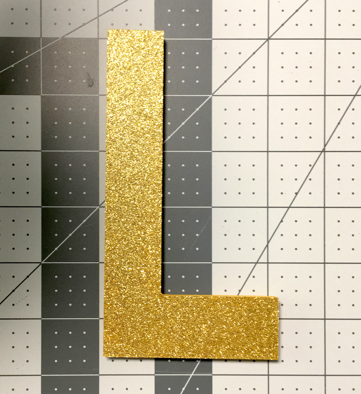 Wood letter L with gold Duck Tape on top