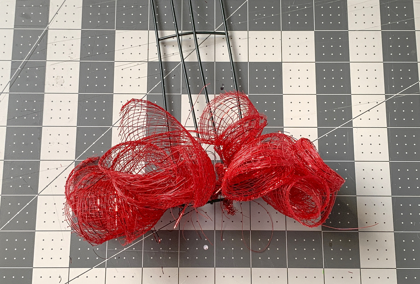 Row of red deco mesh attached to the wreath form