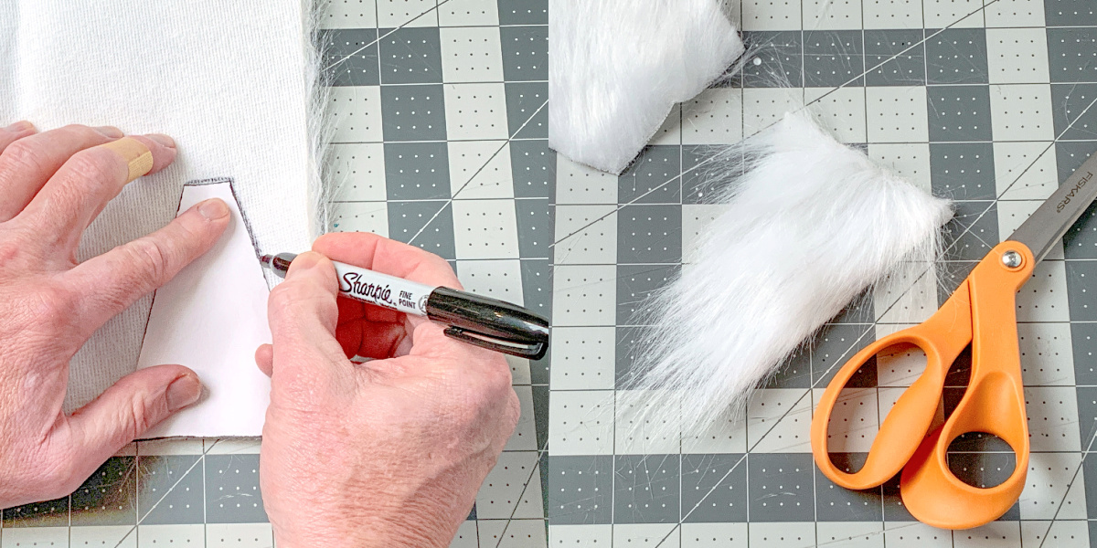 Tracing the beard template onto the back of the faux fur