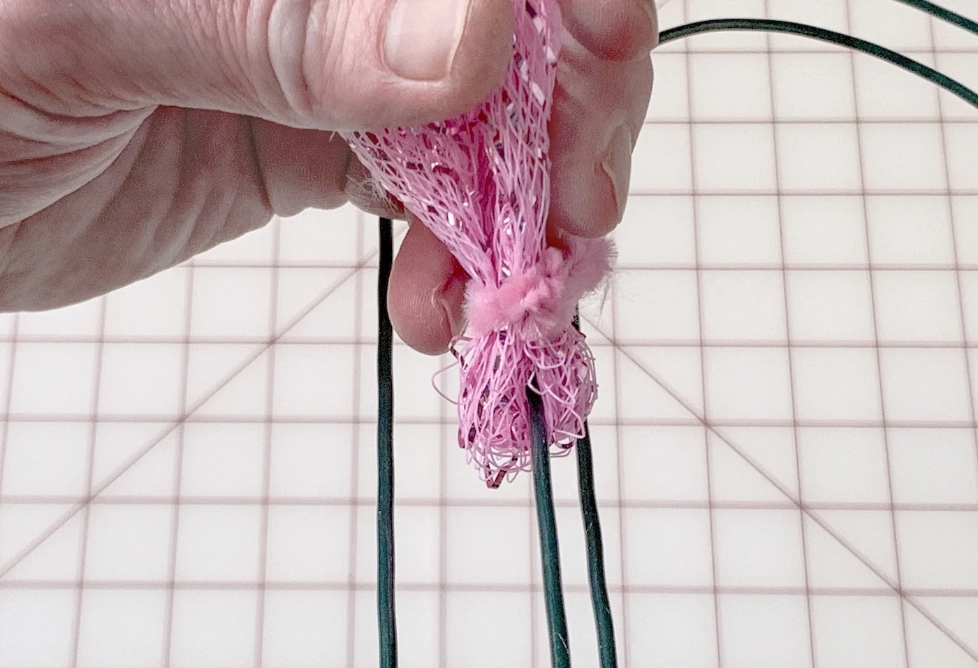 Wrapping a pipe cleaner around the folded mesh