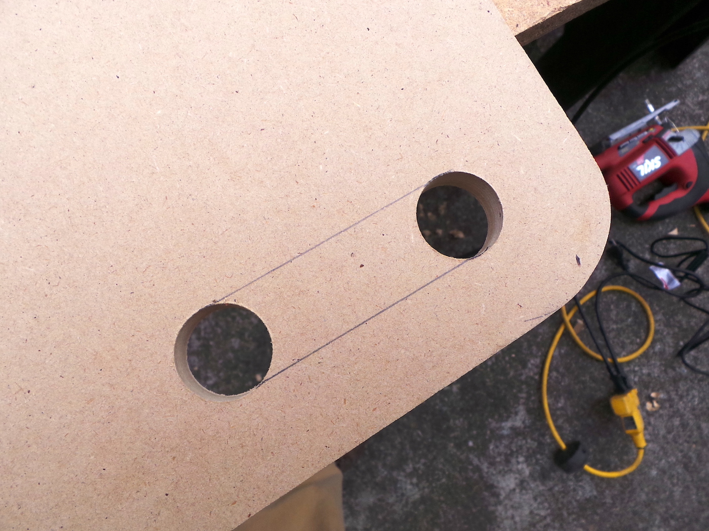 Pencil lines drawn on MDF to connect the holes