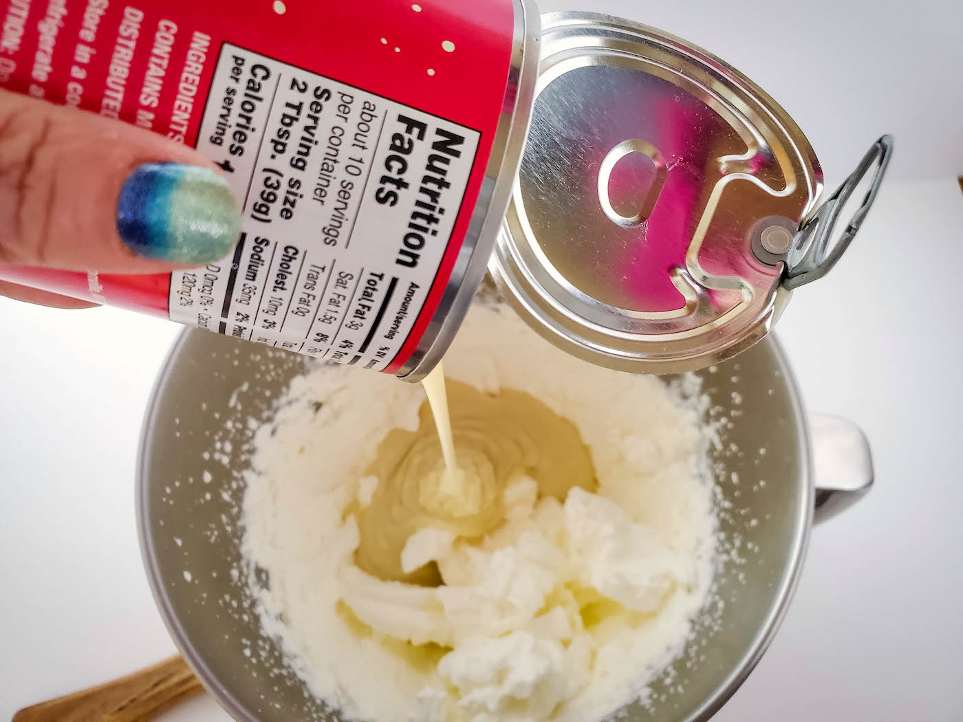 Adding condensed milk to the whipping cream