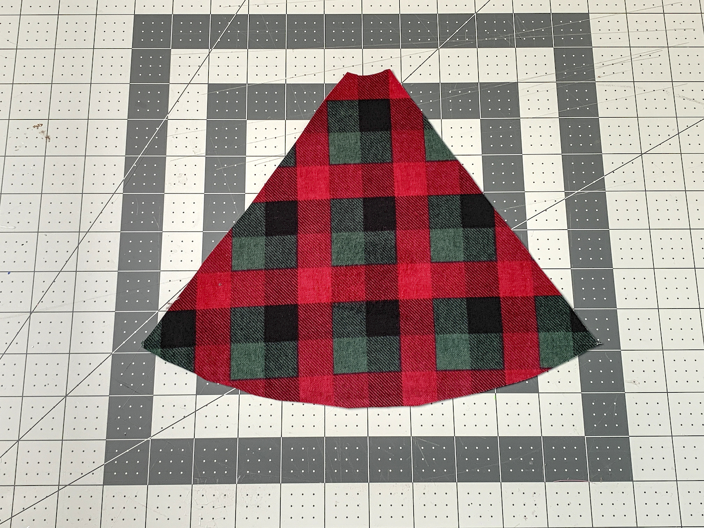Cut piece of plaid fabric on a work surface