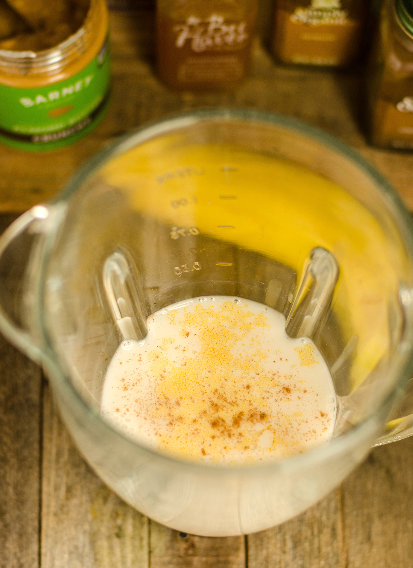Almond milk and spices added to a blender