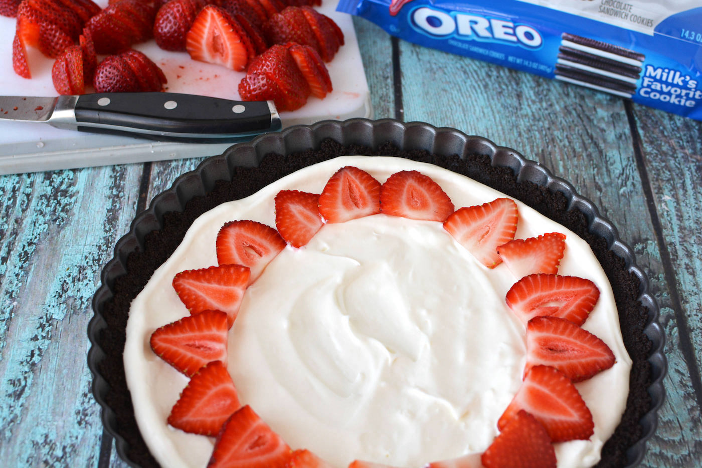 Lining the strawberries on top of the Oreo tart
