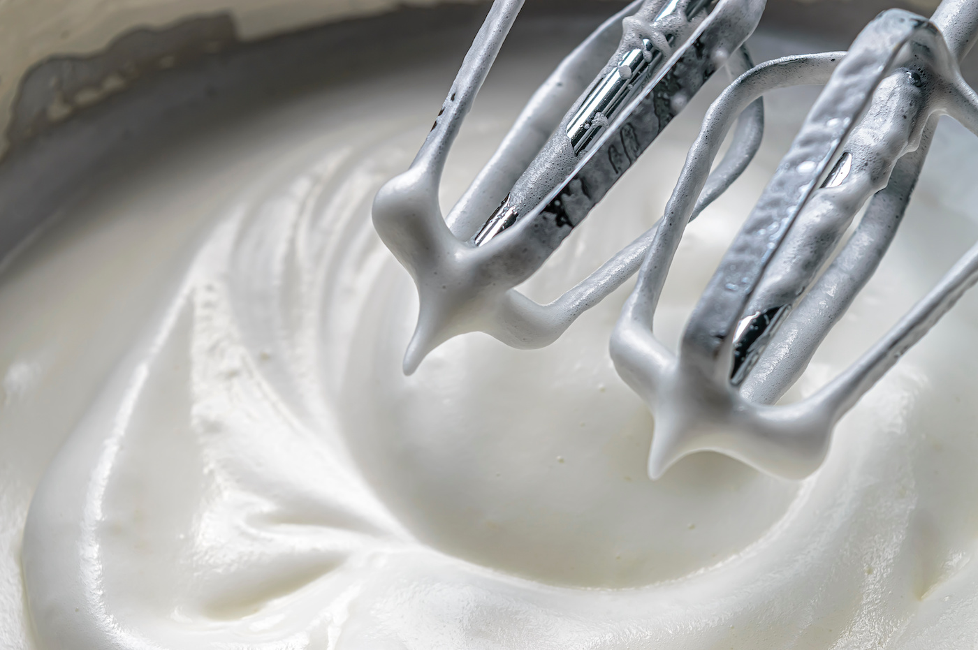 Mixing-whipping-cream-and-sugar-in-a-mixture