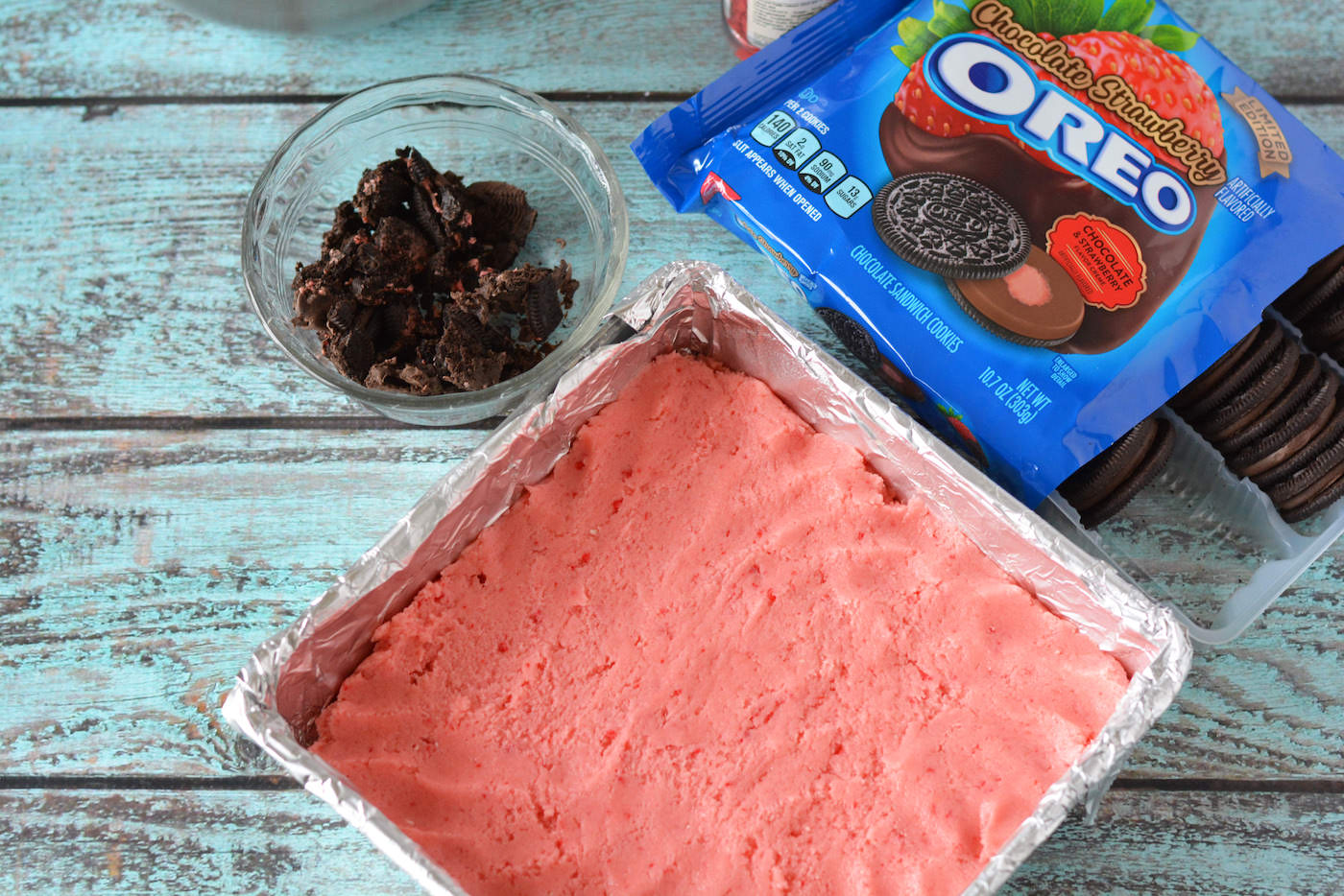 Strawberry brownie mix pressed into a square pan