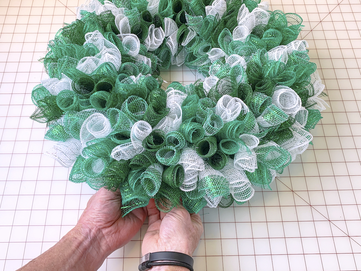 Attaching the final mesh piece to the St. Patrick's Day wreath