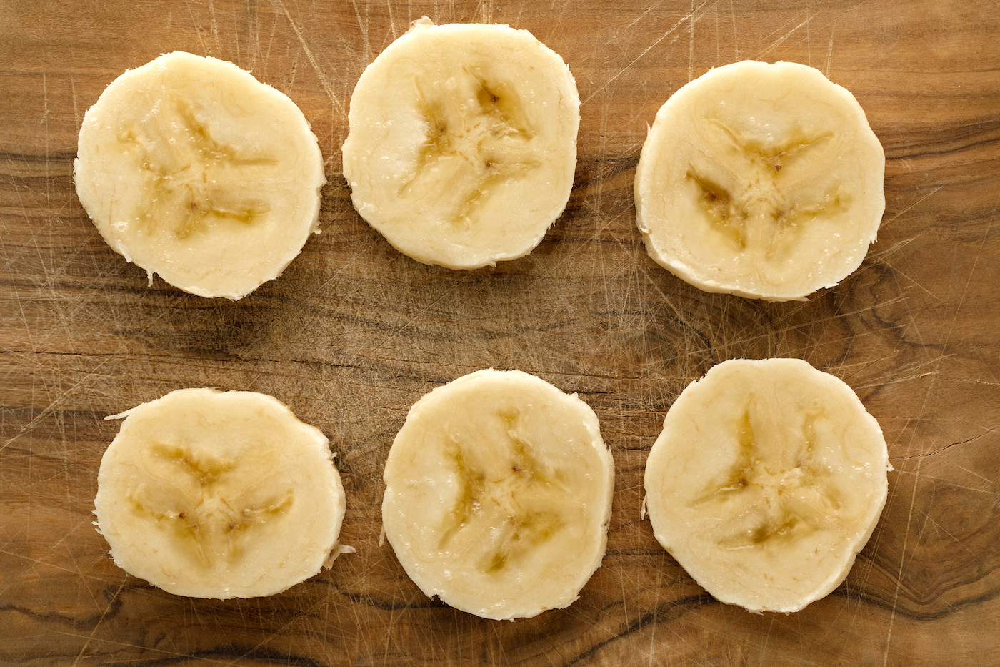 Banana slices on a wooden board