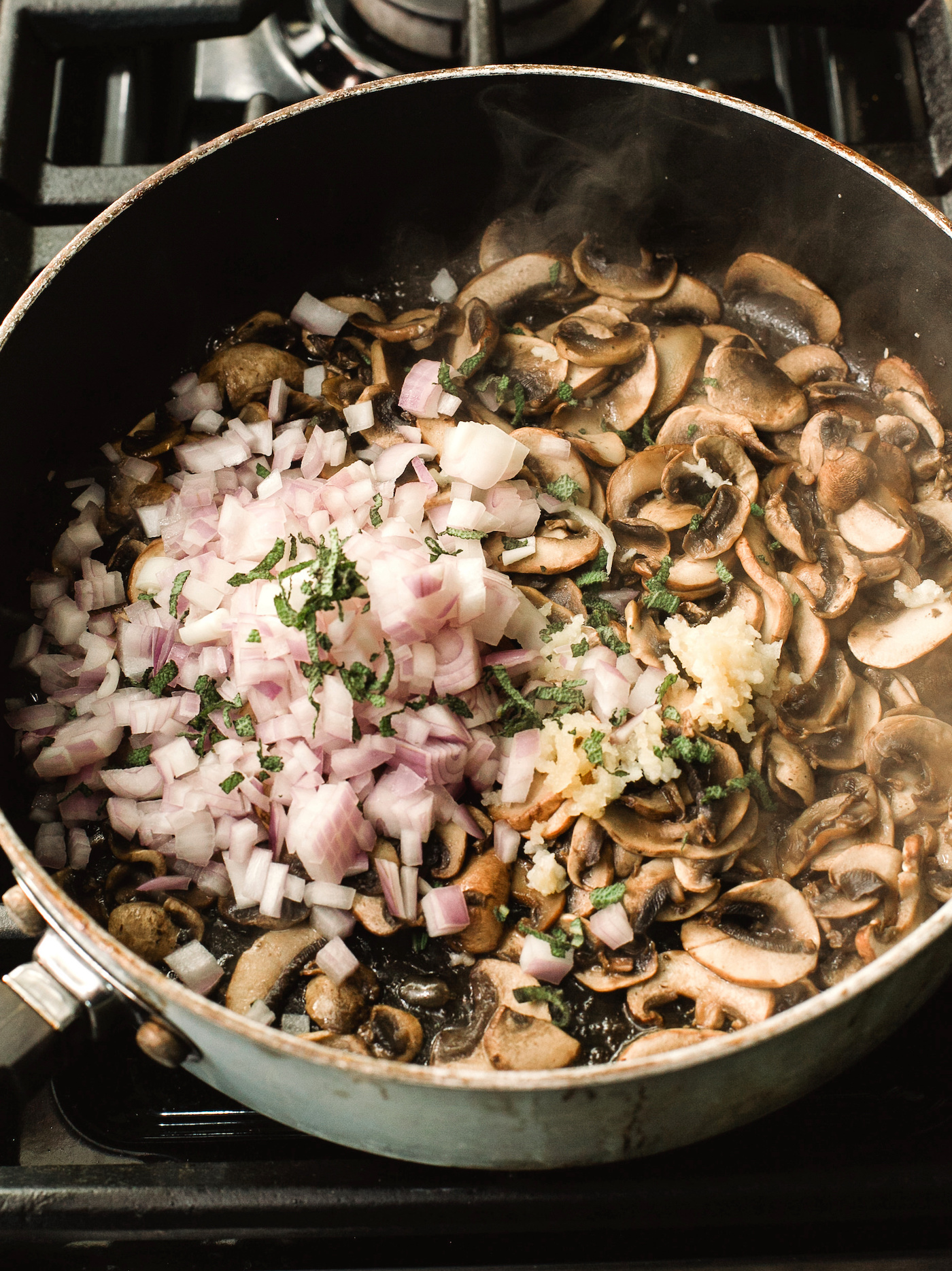 Shallots, garlic, and sage added to the mushrooms