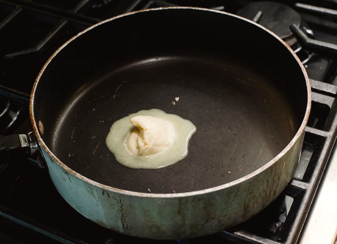 melting butter in a skillet on the stove
