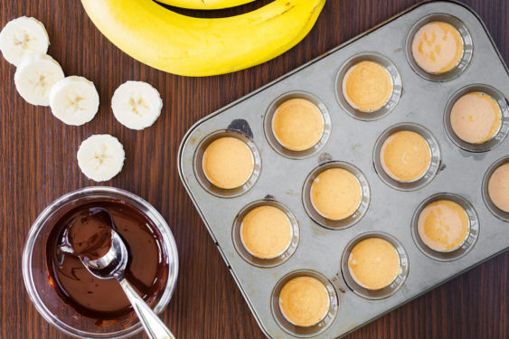 peanut butter spooned into the mini muffin tin