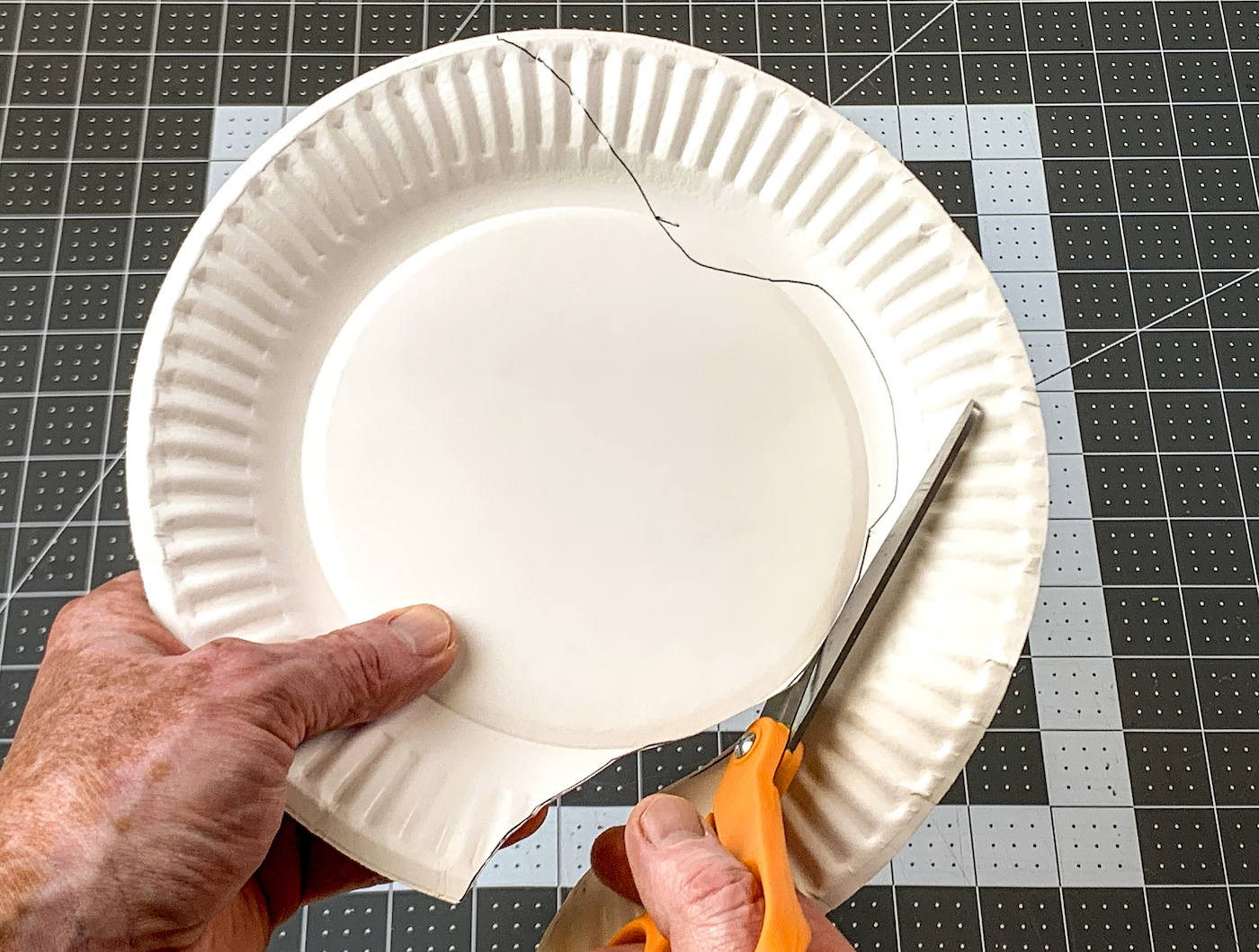 Cutting the body of the turkey out of a paper plate