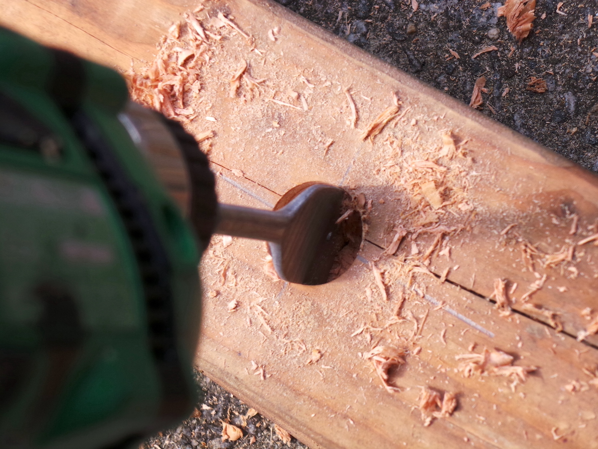 Drilling with a spade bit into a piece of wood