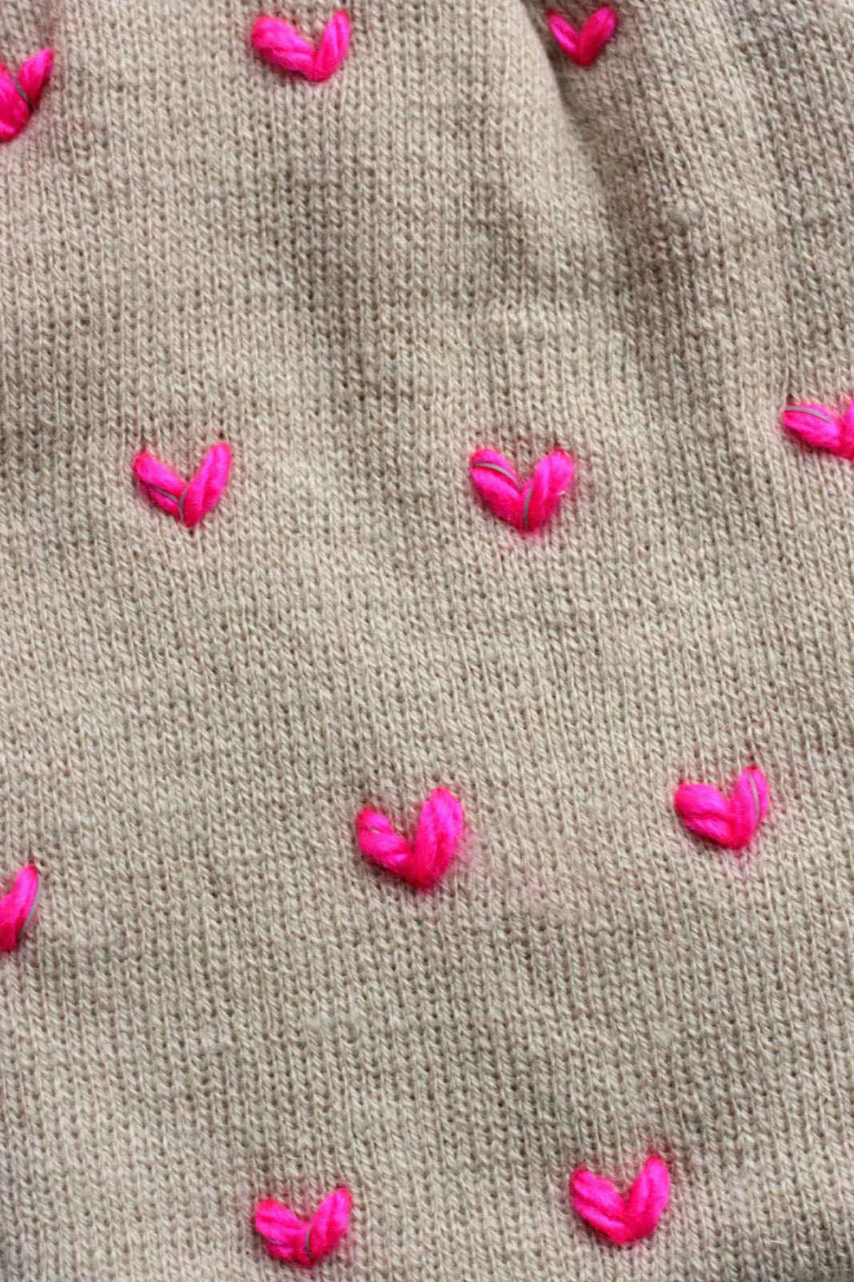Heart pattern stitched into a beanie with yarn