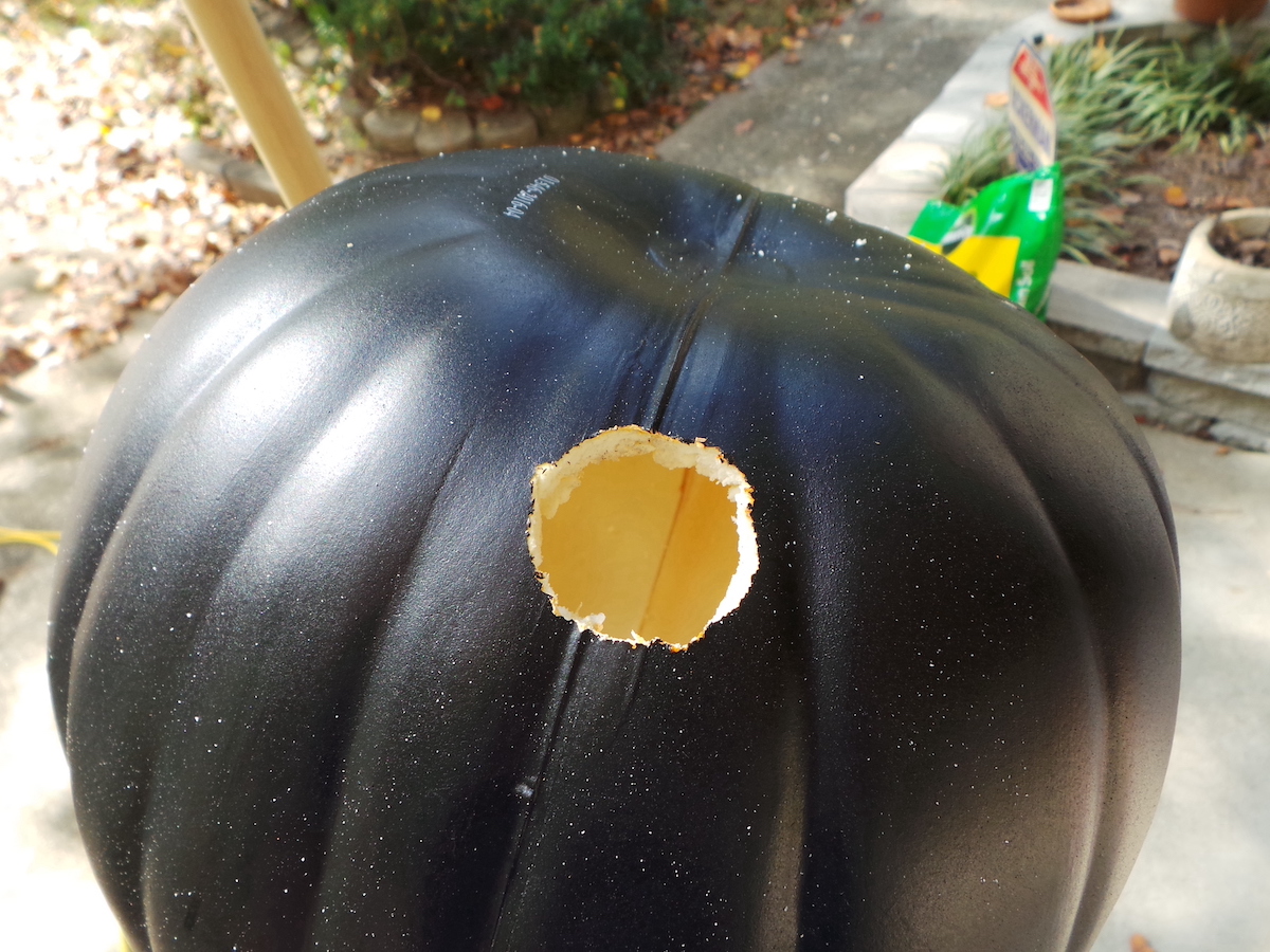 Hole drilled into a black faux pumpkin