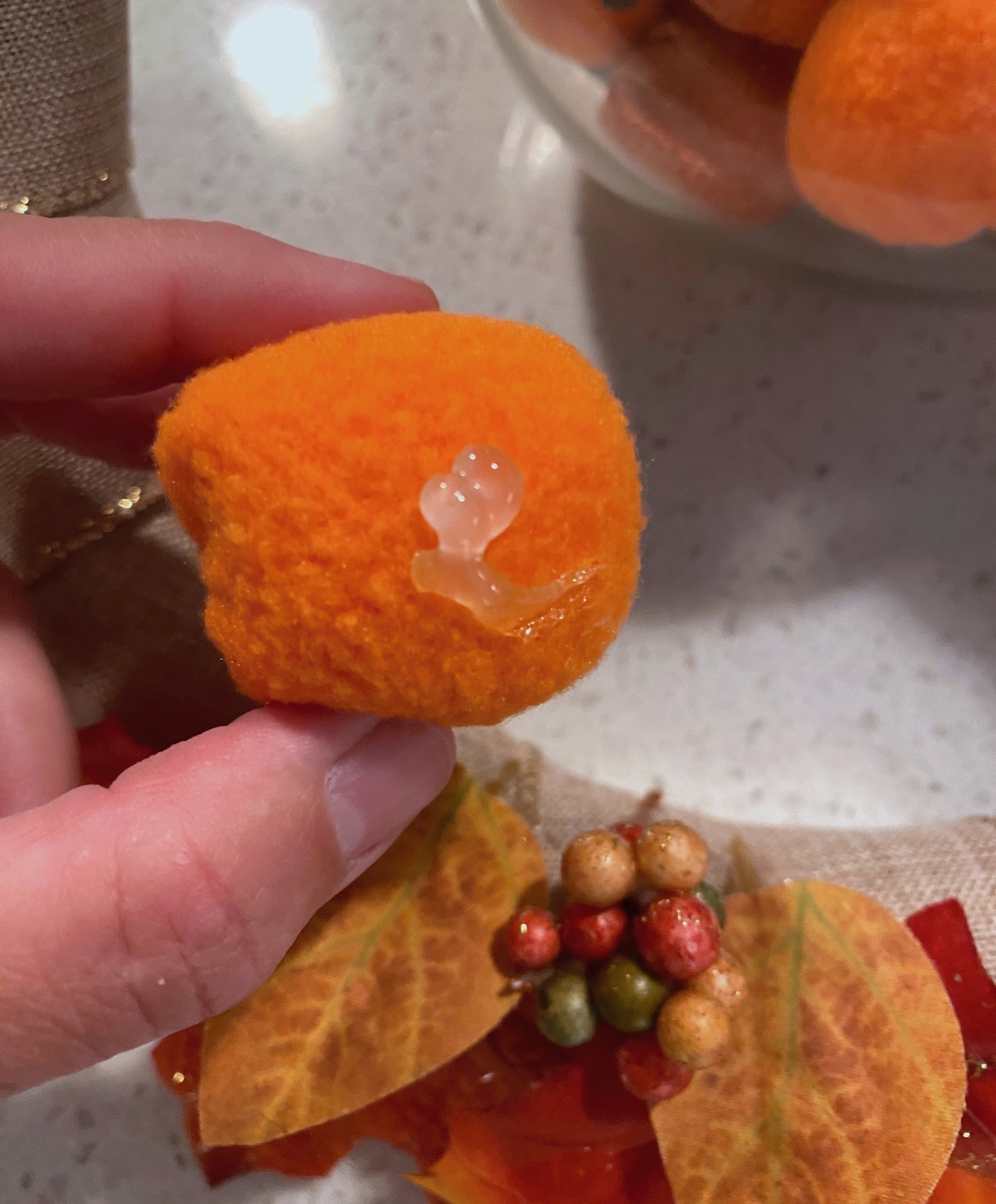 Hot glue on the bottom of a mini pumpkin