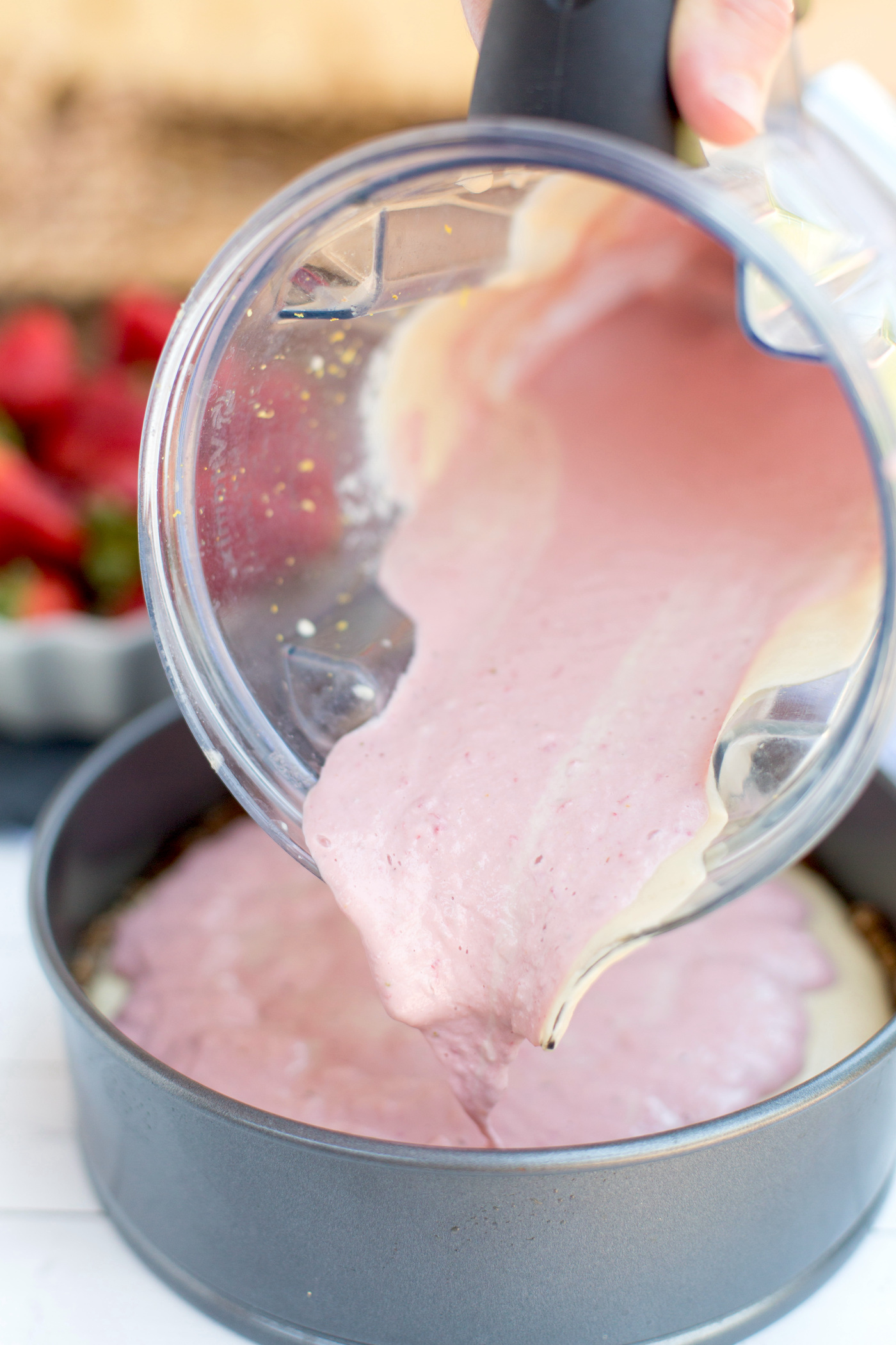 Pour the strawberry cheesecake filling into the springform pan