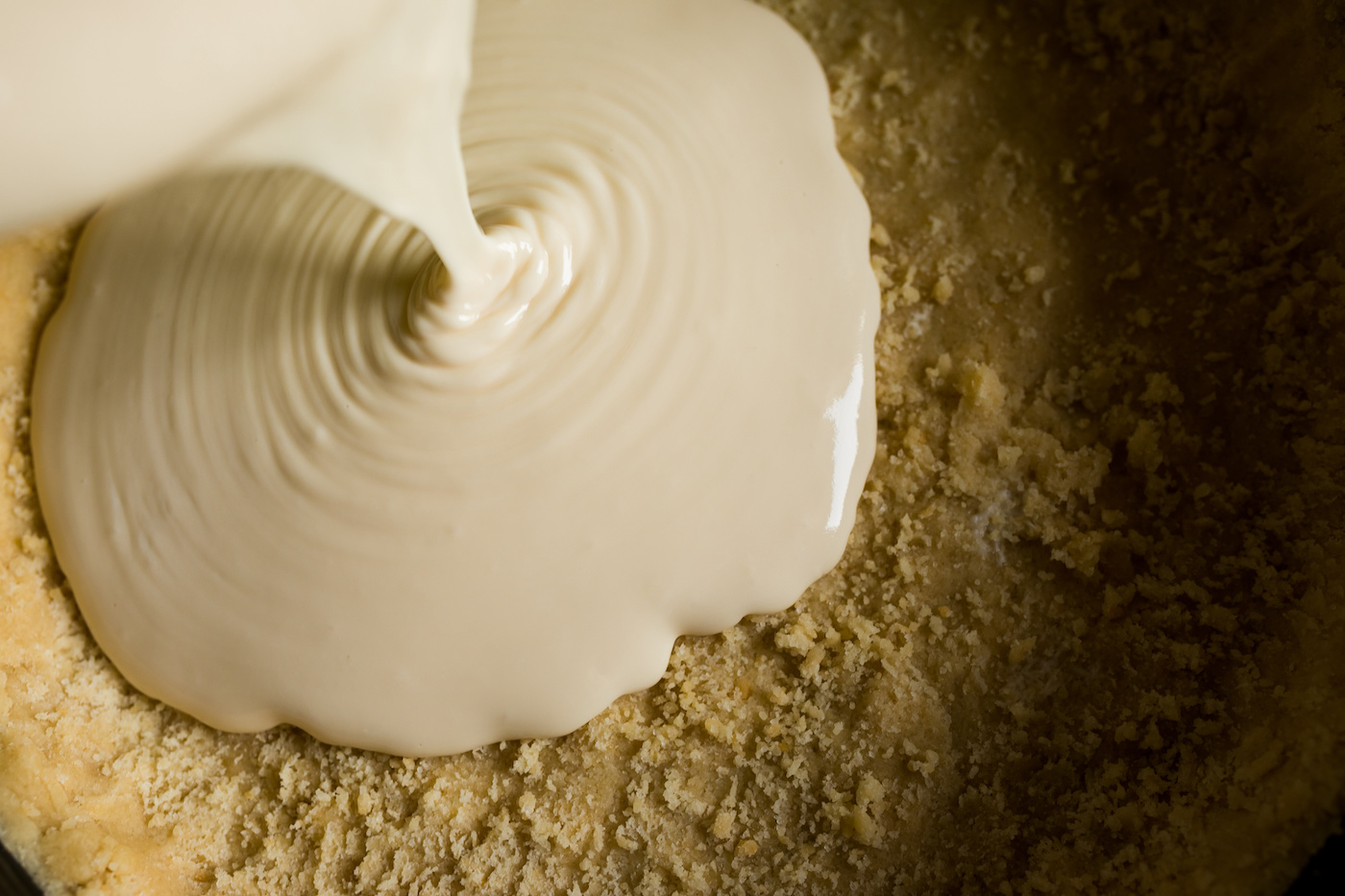 Pouring-cheesecake-batter-onto-a-crust
