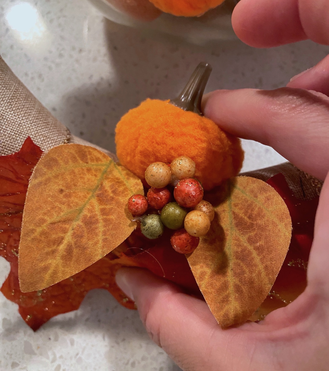 Pressing the pumpkin into the wreath form