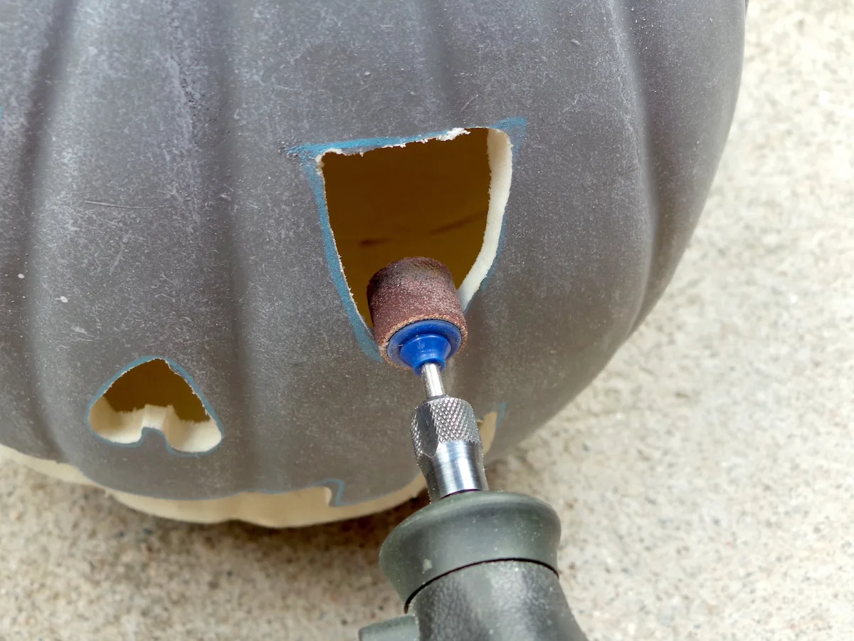 Sanding out the pumpkin carving with a Dremel