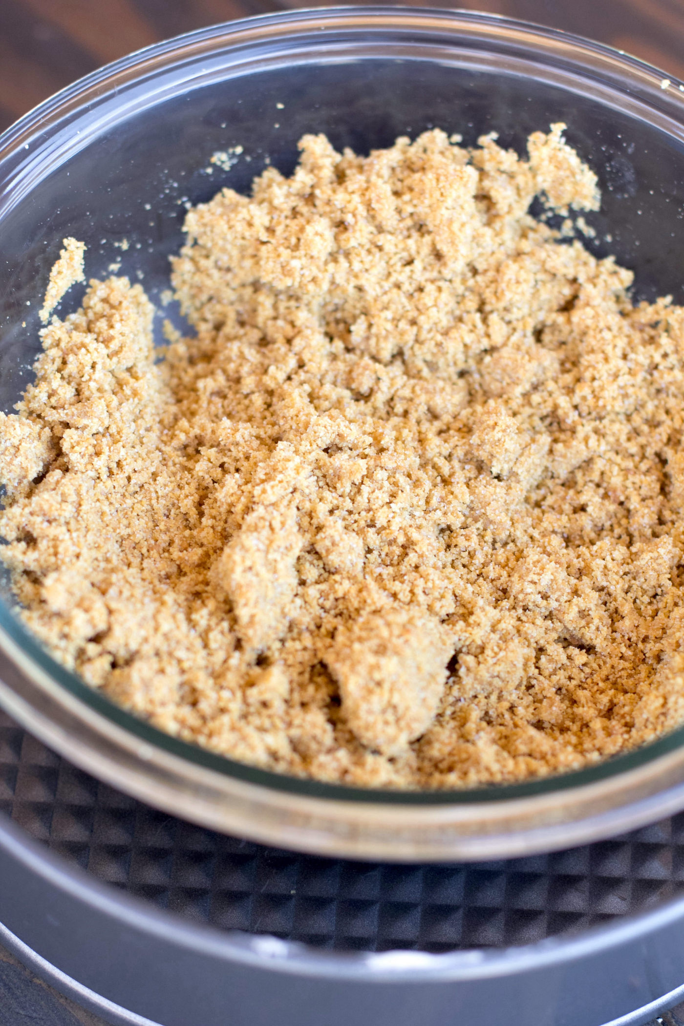 graham cracker crumbs with butter in a bowl