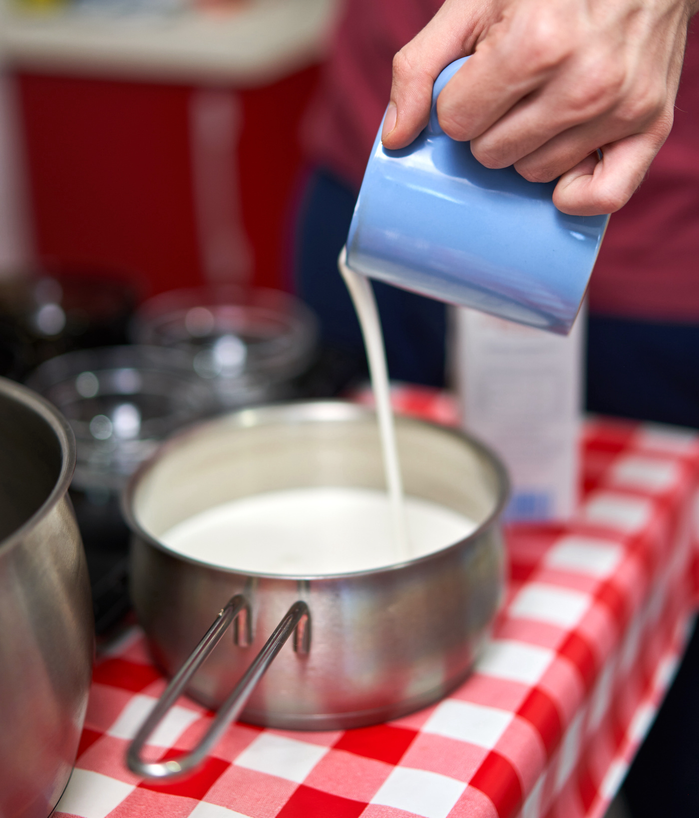 pouring-heavy-cream-into-a-saucepan