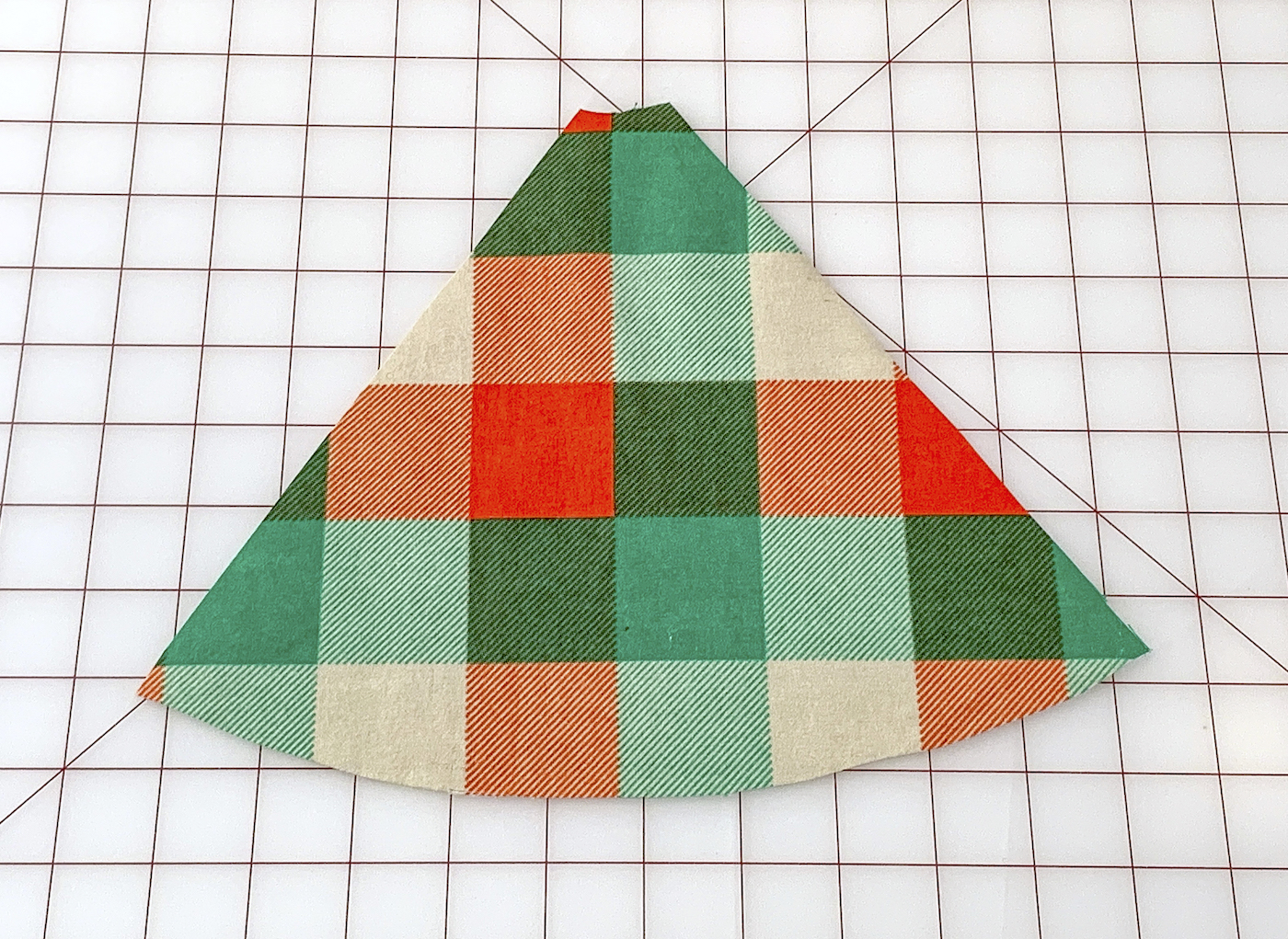 Cut piece of green plaid fabric on a work surface
