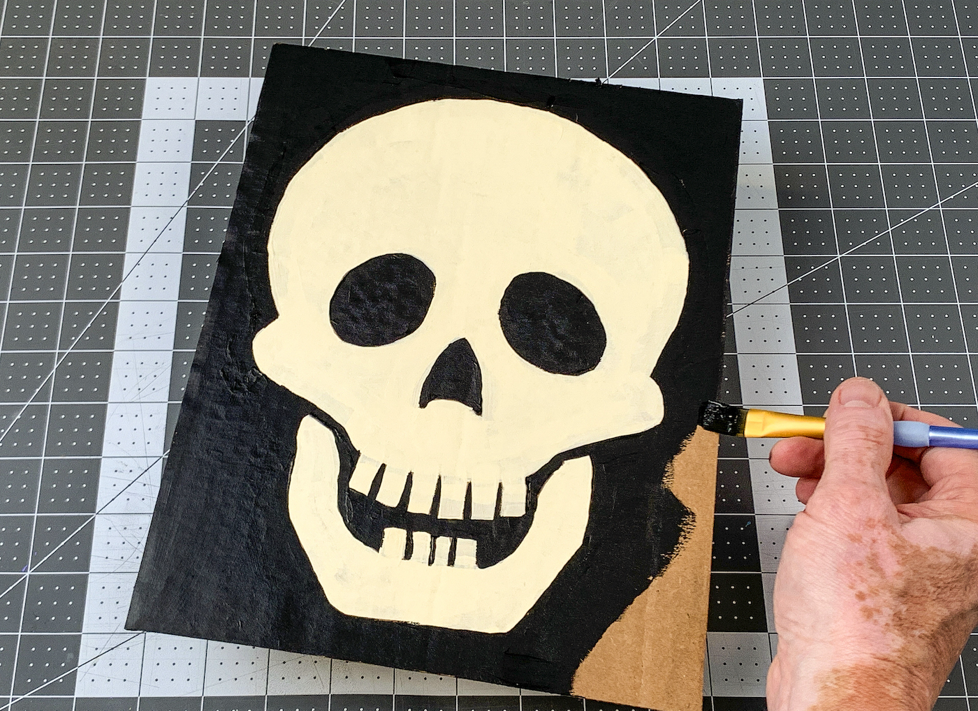 Painting black around the edges of the skull