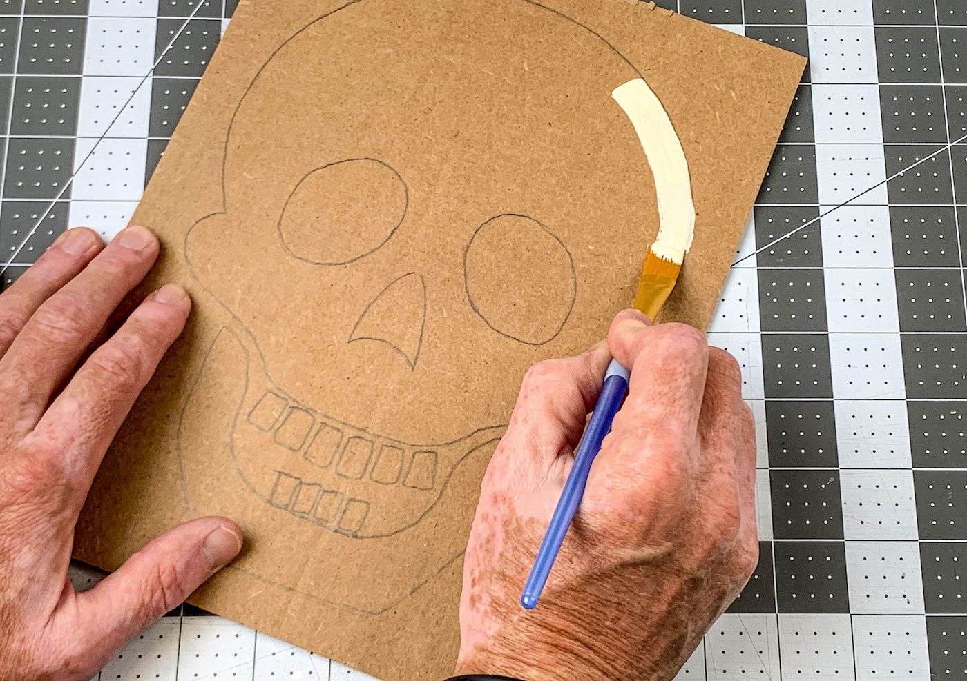 Painting the skull face with ivory acrylic paint