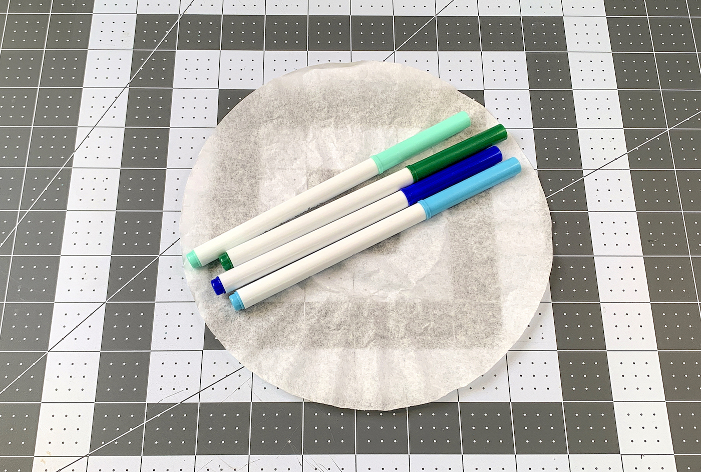 Coffee filter with blue and green markers on top