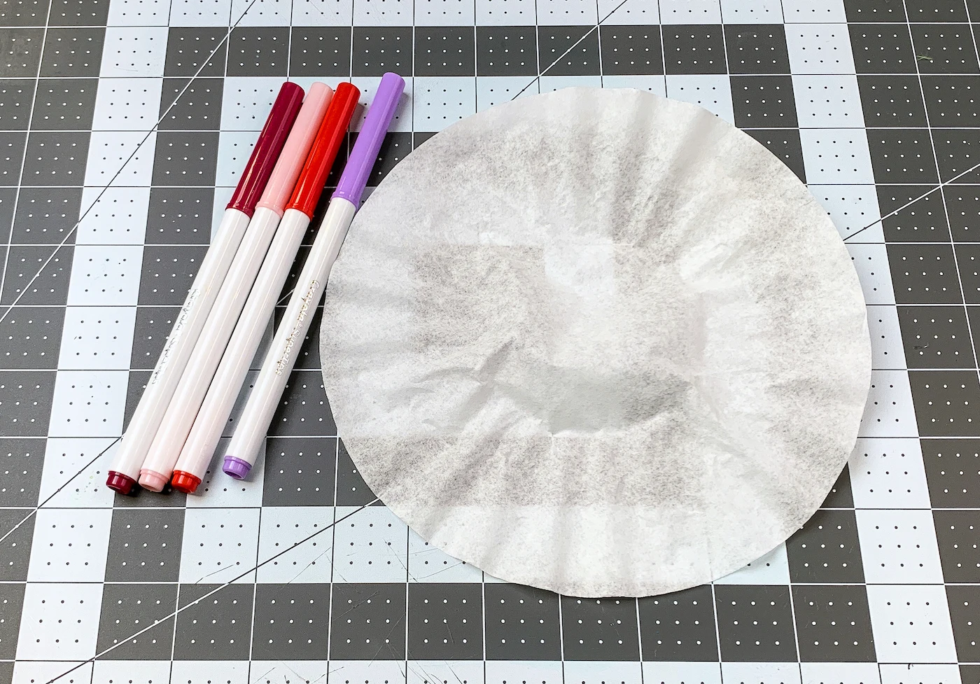 Coffee filter with red, pink, and purple markers