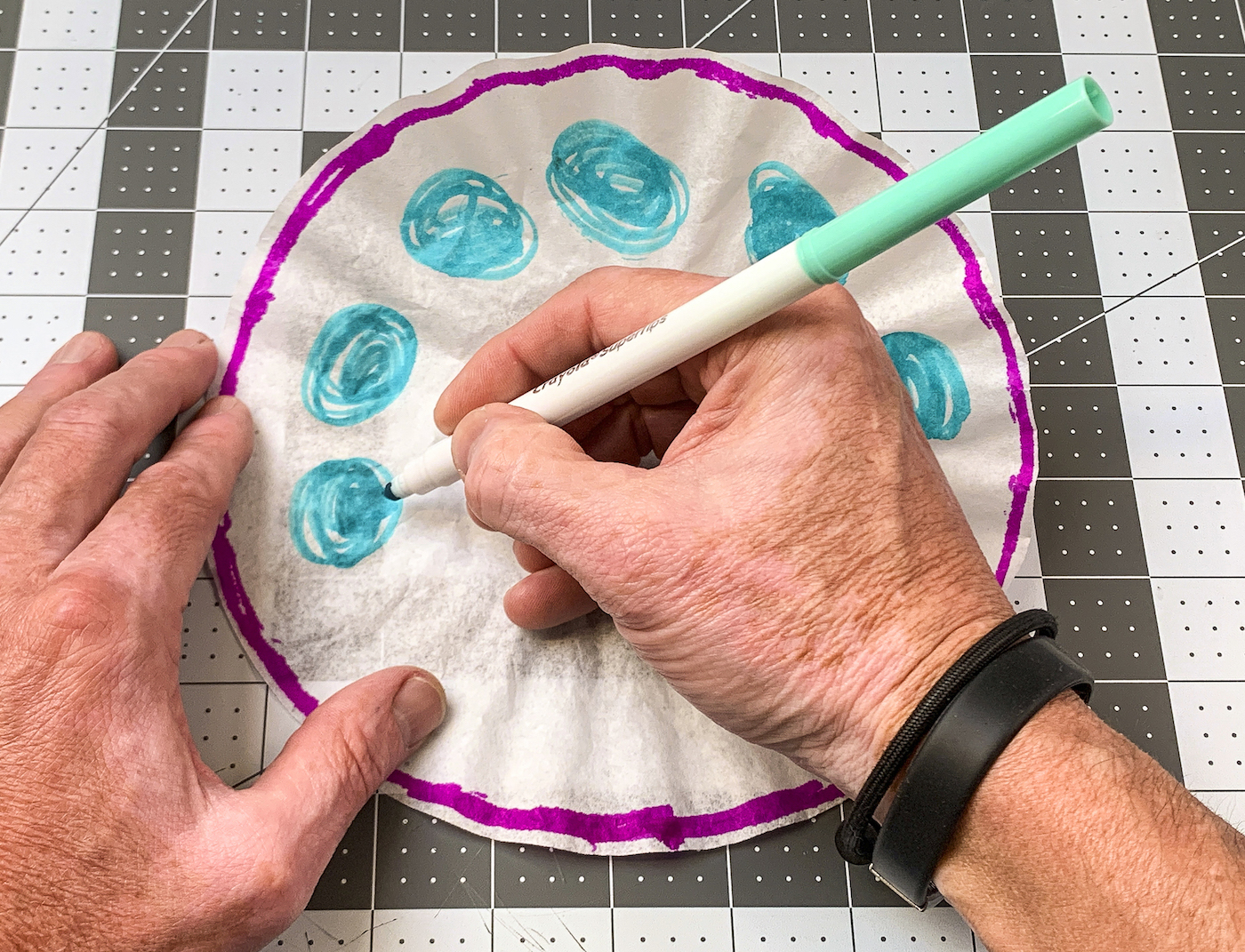 Drawing blue circles on the coffee filter