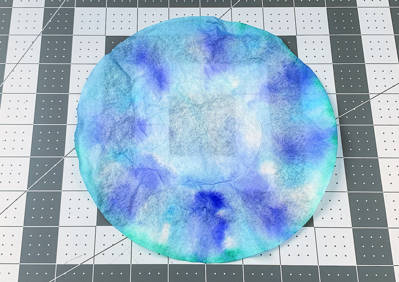 Dried blue, green, and purple coffee filter